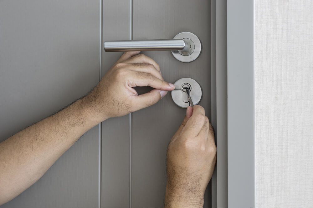 Locksmith opening door during emergency lockout